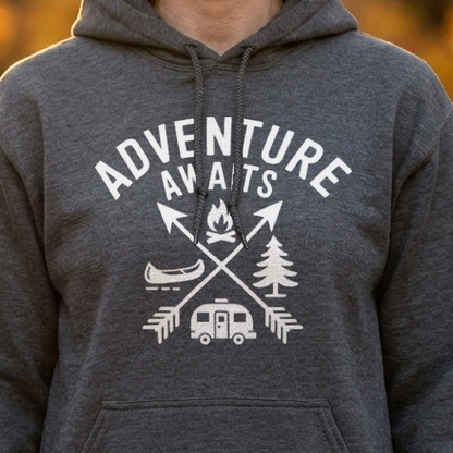 Close-up of a dark gray camping hoodie with a white Adventure Awaits design of crossed arrows, campfire, canoe and camper