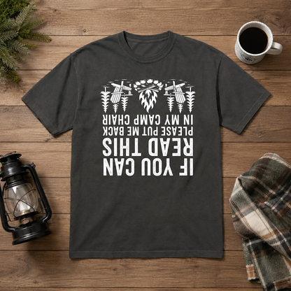 Dark gray If You Can Read This camp chair t-shirt with upside-down white text laid flat on a wooden table with a coffee mug, lantern, and plaid blanket.