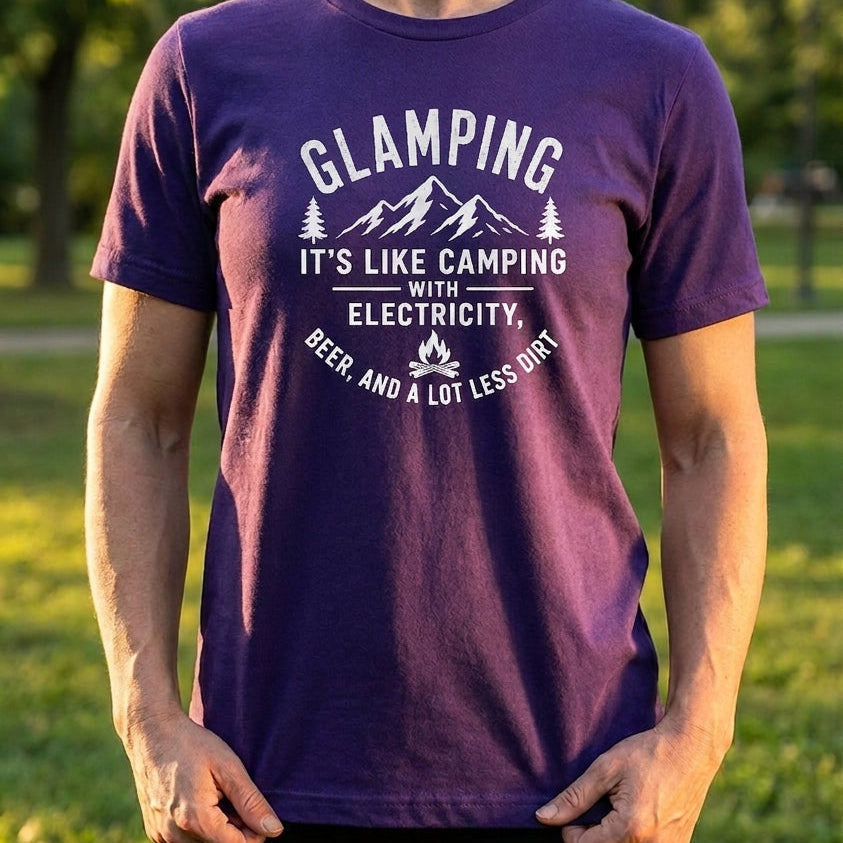 A woman wearing a purple graphic t-shirt with a white printed design that reads 'GLAMPING IT'S LIKE CAMPING WITH ELECTRICITY. BEER AND A LOT LESS DIRTY.