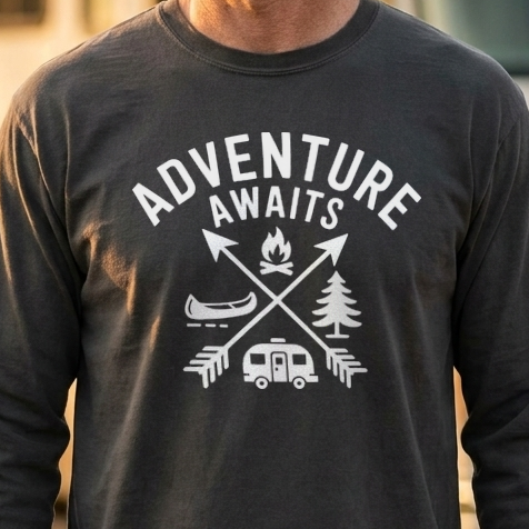 Man in a charcoal gray Adventure Awaits long sleeve camping shirt standing in front of a motorhome