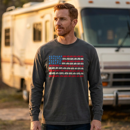 Man in a charcoal gray long sleeve shirt with an RV American flag design standing in front of a motorhome